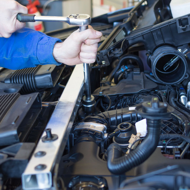 mechanic servicing a car engine